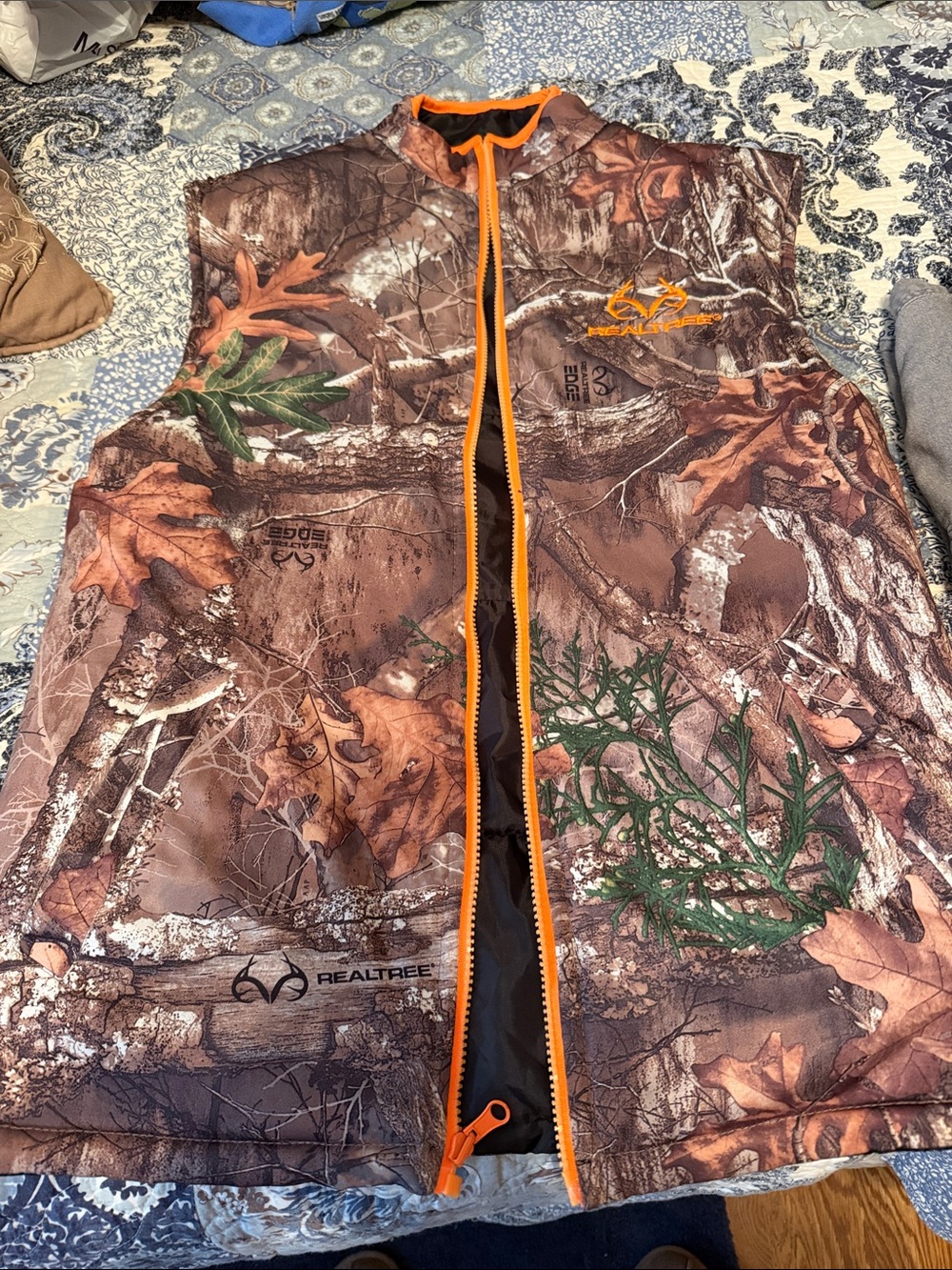 Realtree Brown Camo Vest with Orange Zipper reversible to solid black.